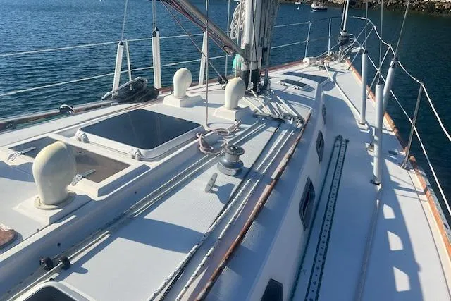 Slide: The Image of 1987 Sabre 42 K/CB sailboat deck with winches and rigging, docked on calm water. - 19