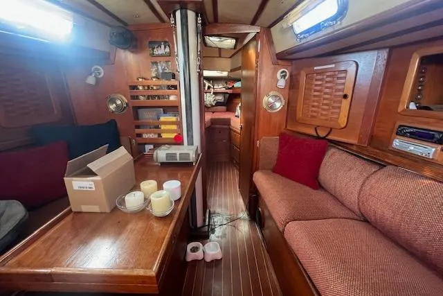 Slide: The Image of Interior of 1987 Sabre 42 K/CB sailboat with wooden furnishings and cozy seating. - 2