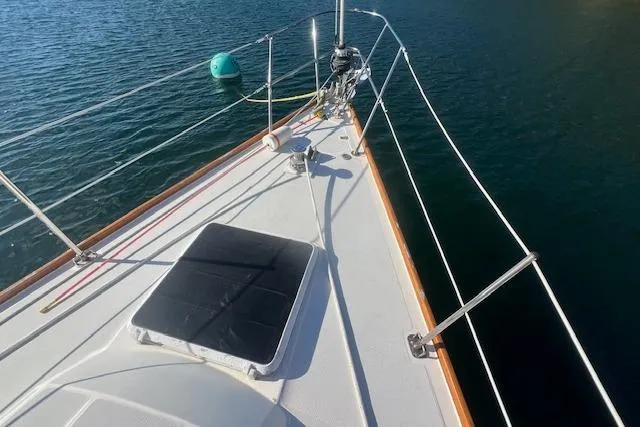 Slide: The Image of 1987 Sabre 42 K/CB sailboat deck with railing, moored on calm water. - 20