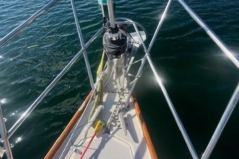 Slide: The Image of 1987 Sabre 42 K/CB sailboat bow with anchor and railing over water. - 22