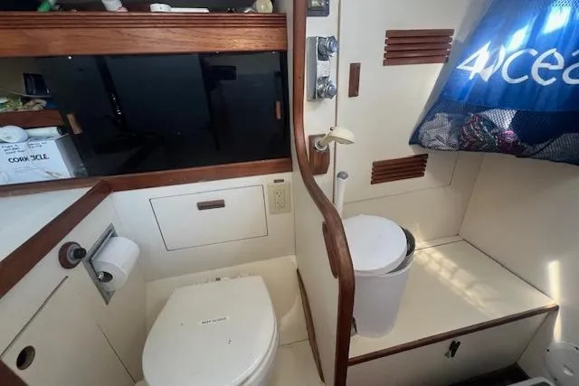 Slide: The Image of 1987 Sabre 42 K/CB yacht bathroom with toilet, sink, and storage. - 26