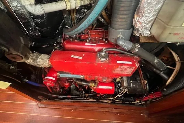 Slide: The Image of Engine compartment of a 1987 Sabre 42 K/CB sailboat, featuring a red marine engine. - 28