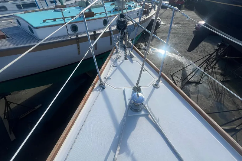 Slide: The Image of 1987 Sabre 42 K/CB sailboat deck with rigging and winch in a marina. - 32
