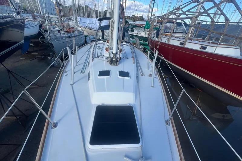 Slide: The Image of 1987 Sabre 42 K/CB sailboat deck view in marina, surrounded by other boats. - 33