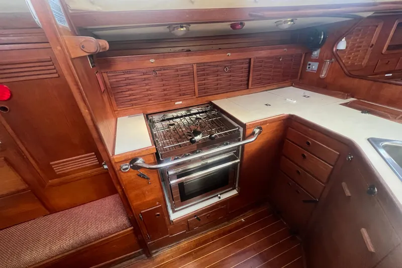 Slide: The Image of 1987 Sabre 42 K/CB yacht interior kitchen with wooden cabinetry and stove. - 36