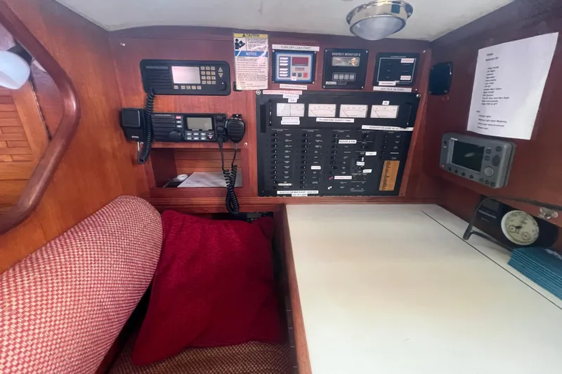 Slide: The Image of Navigation station of 1987 Sabre 42 K/CB sailboat with control panels and communication equipment. - 37