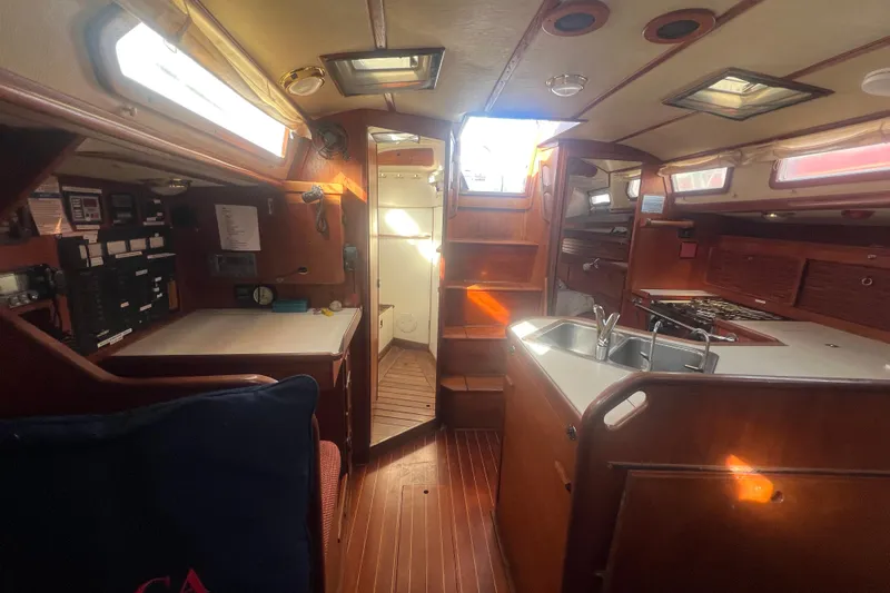 Slide: The Image of 1987 Sabre 42 K/CB yacht interior with wooden cabinetry and compact kitchen area. - 38