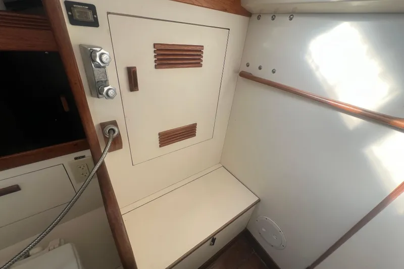 Slide: The Image of Interior of 1987 Sabre 42 K/CB sailboat, featuring wooden accents and storage compartment. - 40