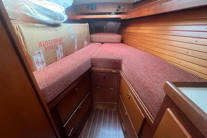 Slide: The Image of Cozy cabin interior of 1987 Sabre 42 K/CB sailboat with red cushions and wooden paneling. - 41