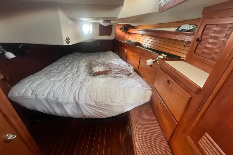 Slide: The Image of Cozy cabin interior of 1987 Sabre 42 K/CB sailboat with wooden furnishings and bed. - 43