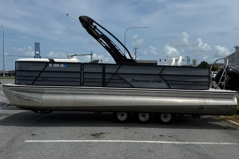 The Image of 2025 Berkshire 24E CTS 2.75 pontoon boat parked on a trailer, side view. - 0