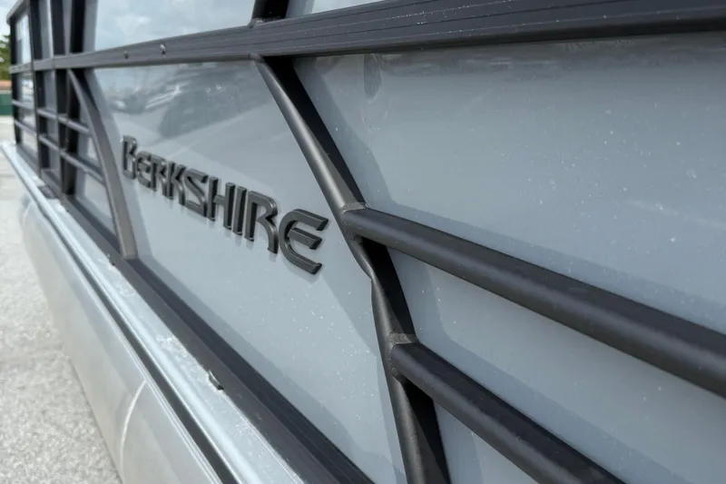Slide: The Image of 2025 Berkshire 24E CTS 2.75 boat side view with logo and railing detail. - 16