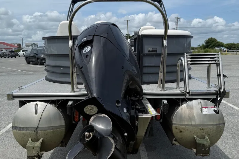 Slide: The Image of 2025 Berkshire 24E CTS 2.75 pontoon boat with powerful outboard motor in parking lot. - 4
