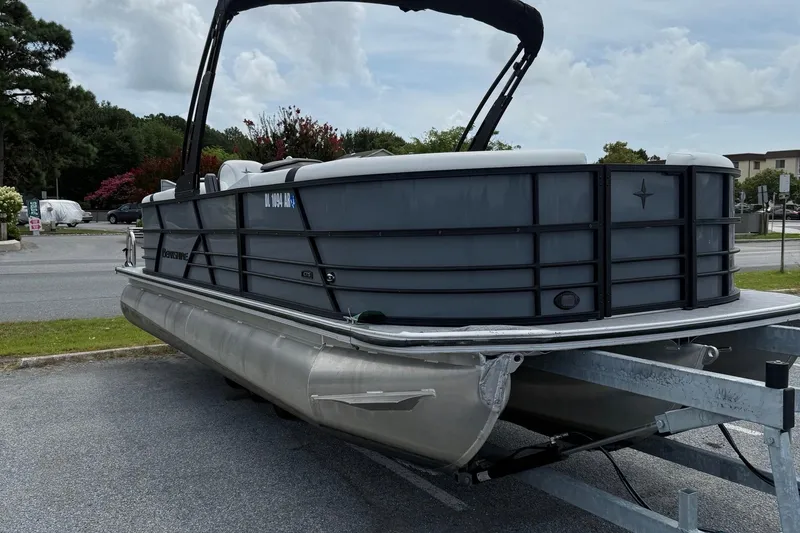 Slide: The Image of 2025 Berkshire 24E CTS 2.75 pontoon boat on trailer, parked outdoors. - 7