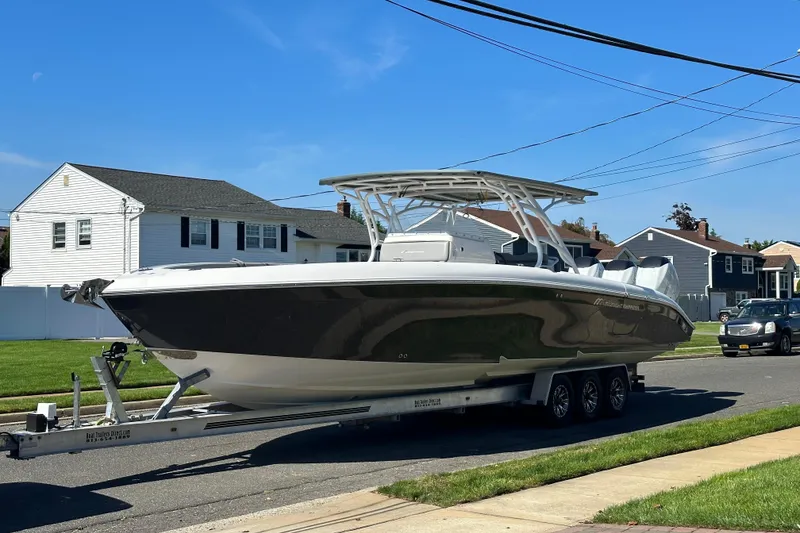 The Image of 2016 Midnight Express 37 Open boat on trailer in suburban neighborhood. - 1