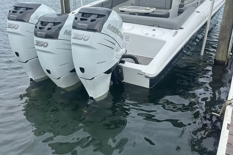 Slide: The Image of 2016 Midnight Express 37 Open with triple Mercury 350 Verado engines docked in water. - 11