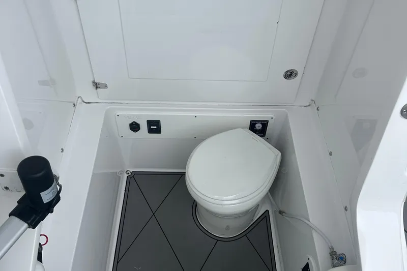 Slide: The Image of 2016 Midnight Express 37 Open boat interior with a compact marine toilet. - 6