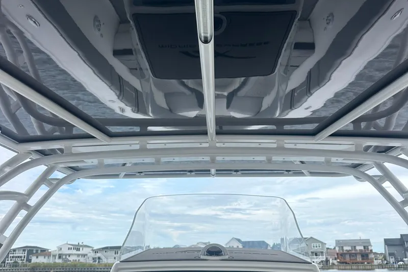 Slide: The Image of 2016 Midnight Express 37 Open boat with sleek roof design and waterfront view. - 9