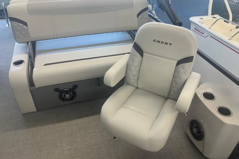 Slide: The Image of Luxurious seating on 2025 Crest 240 Classic LX SLSC boat with cup holders and speakers. - 10