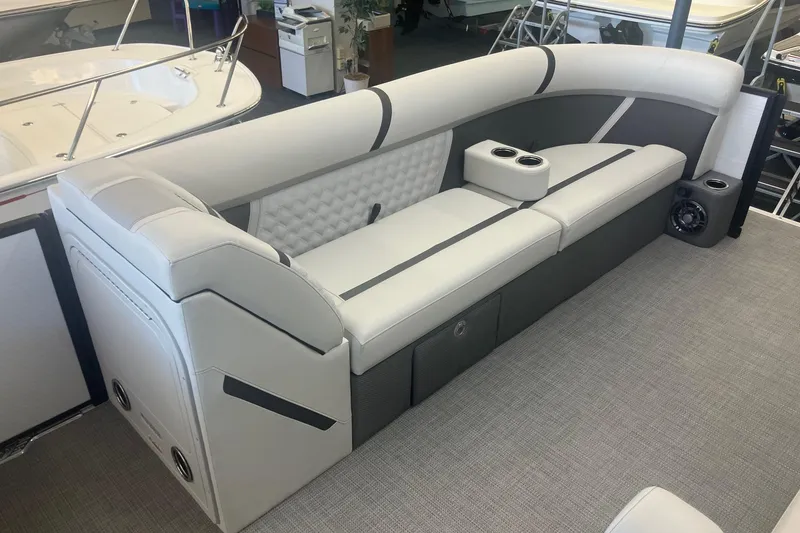 Slide: The Image of 2025 Crest 240 Classic LX SLSC boat interior with sleek seating and cup holders. - 12