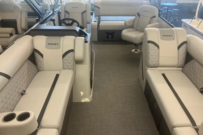 Slide: The Image of Luxurious interior of 2025 Crest 240 Classic LX SLSC pontoon boat with plush seating. - 13