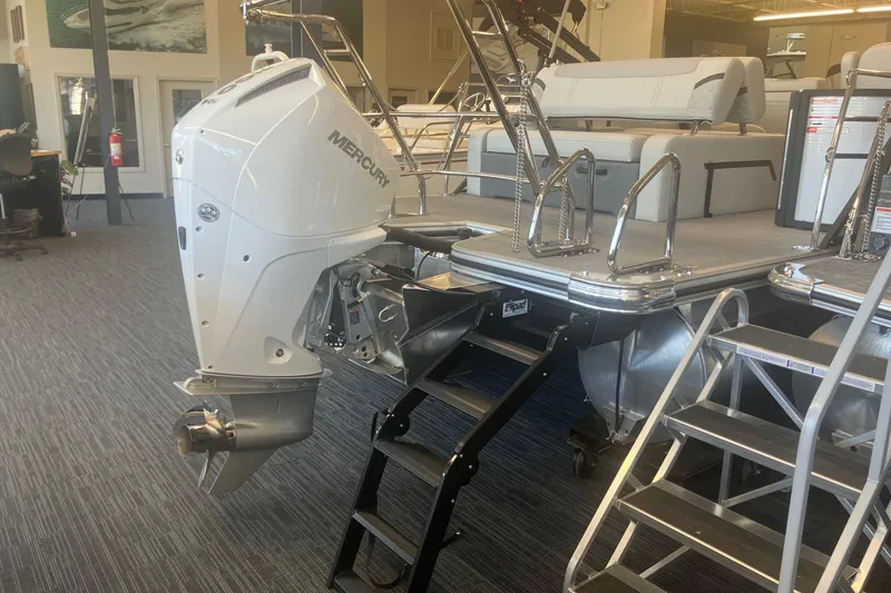 Slide: The Image of 2025 Crest 240 Classic LX SLSC boat with Mercury outboard motor in showroom. - 3