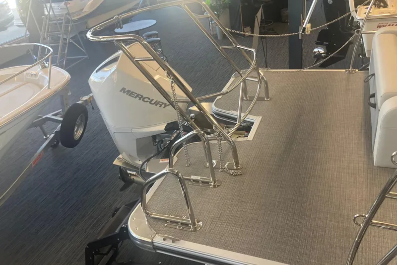 Slide: The Image of 2025 Crest 240 Classic LX SLSC boat with Mercury outboard motor, showroom display. - 4