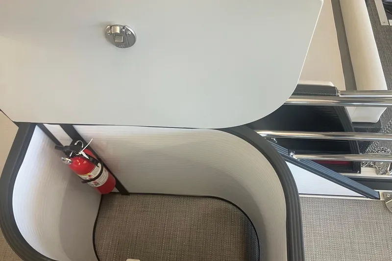 Slide: The Image of 2025 Crest 240 Classic LX SLSC boat interior with fire extinguisher and seating area. - 6