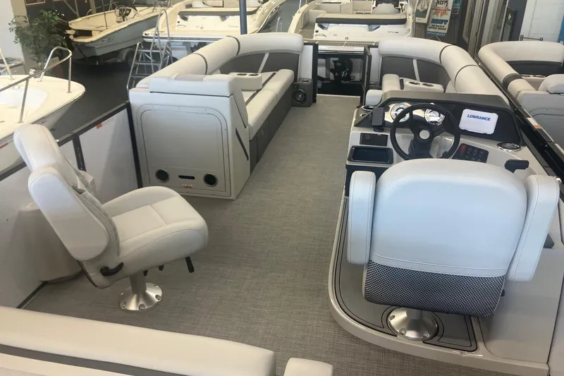 Slide: The Image of 2025 Crest 240 Classic LX SLSC pontoon boat interior with modern seating and steering console. - 7