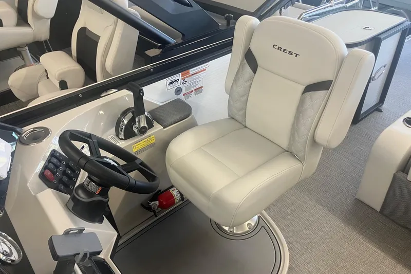 Slide: The Image of 2025 Crest 240 Classic LX SLSC boat interior with steering wheel and captain's chair. - 8