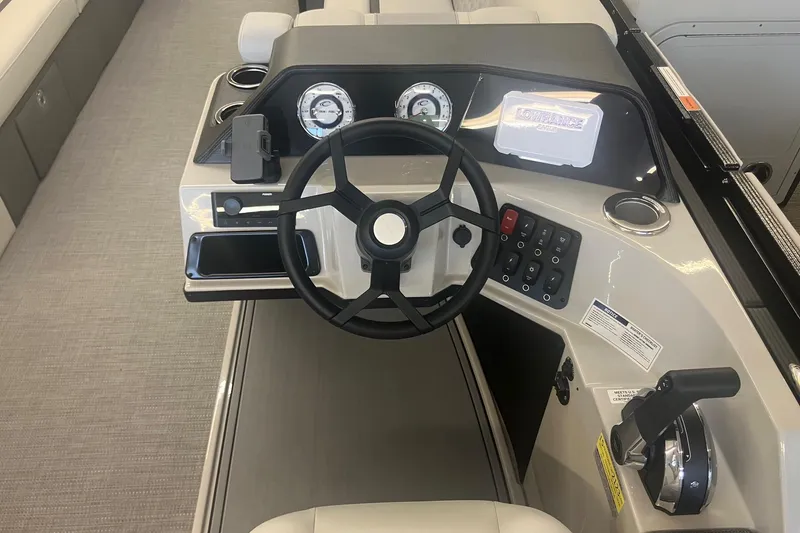 Slide: The Image of 2025 Crest 240 Classic LX SLSC boat dashboard with steering wheel and control panel. - 9