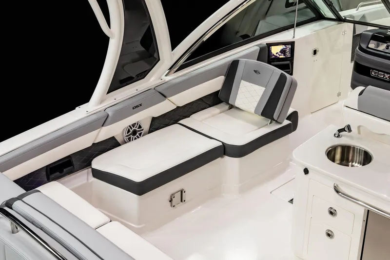 Slide: The Image of 2026 Chaparral 310 OSX boat interior with sleek seating and modern amenities. - 13