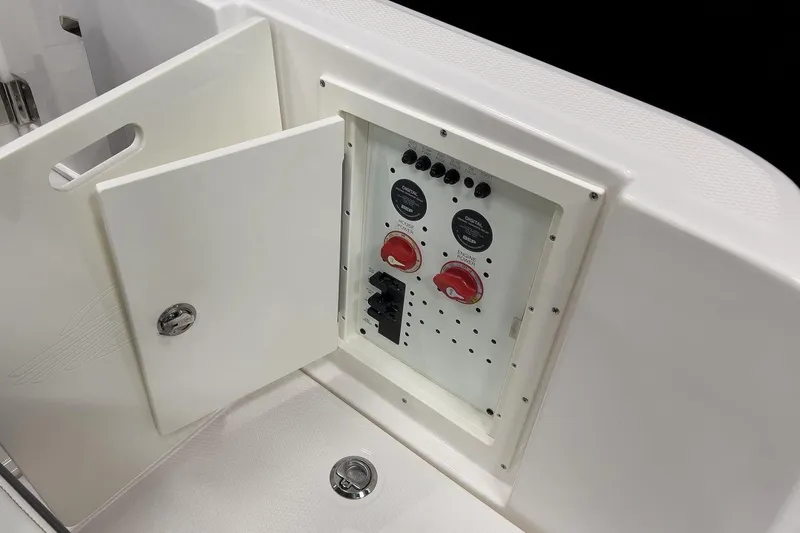 Slide: The Image of 2026 Chaparral 310 OSX boat control panel with open access door. - 19