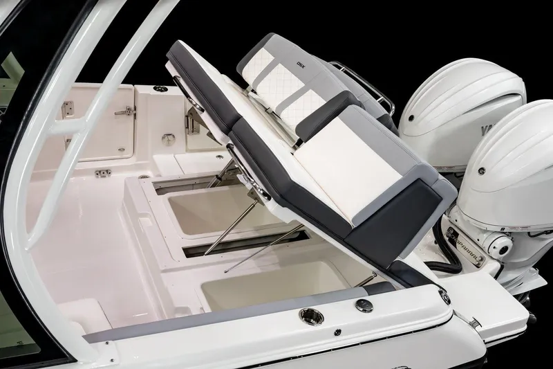 Slide: The Image of 2026 Chaparral 310 OSX boat interior with adjustable seating and dual outboard engines. - 21