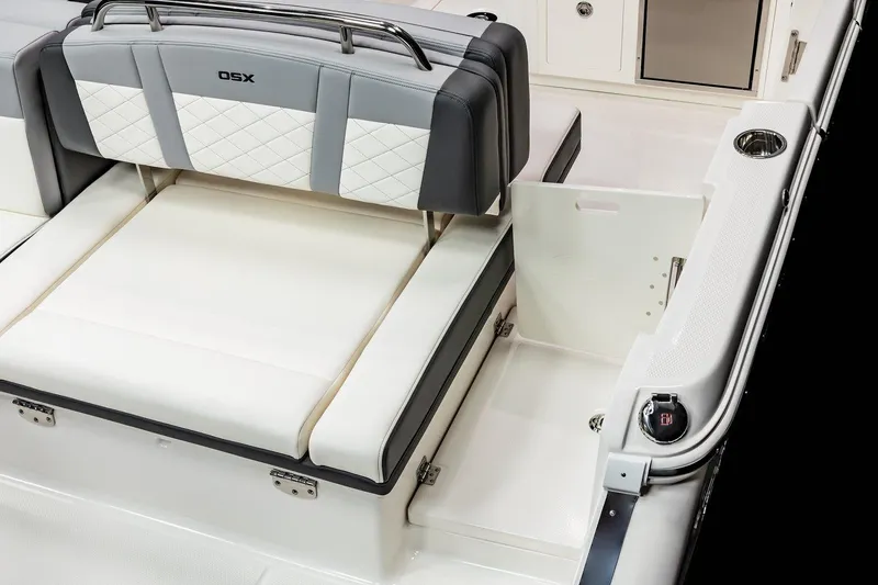 Slide: The Image of 2026 Chaparral 310 OSX boat interior with cushioned seating and storage area. - 22