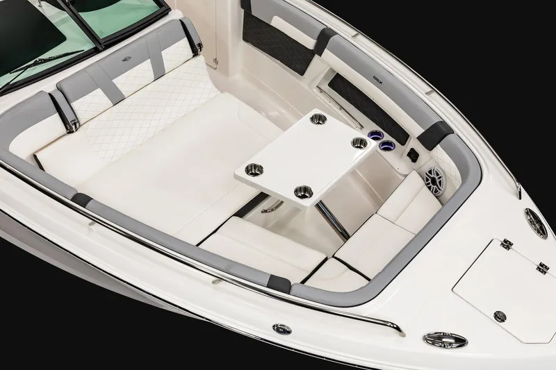 Slide: The Image of 2026 Chaparral 310 OSX boat interior with white seating and table. - 5