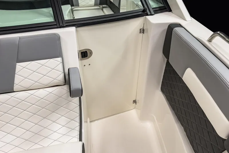Slide: The Image of 2026 Chaparral 310 OSX boat interior with elegant quilted seating and sleek design. - 6