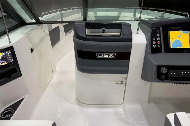 Slide: The Image of 2026 Chaparral 310 OSX boat cockpit with modern navigation displays and controls. - 8