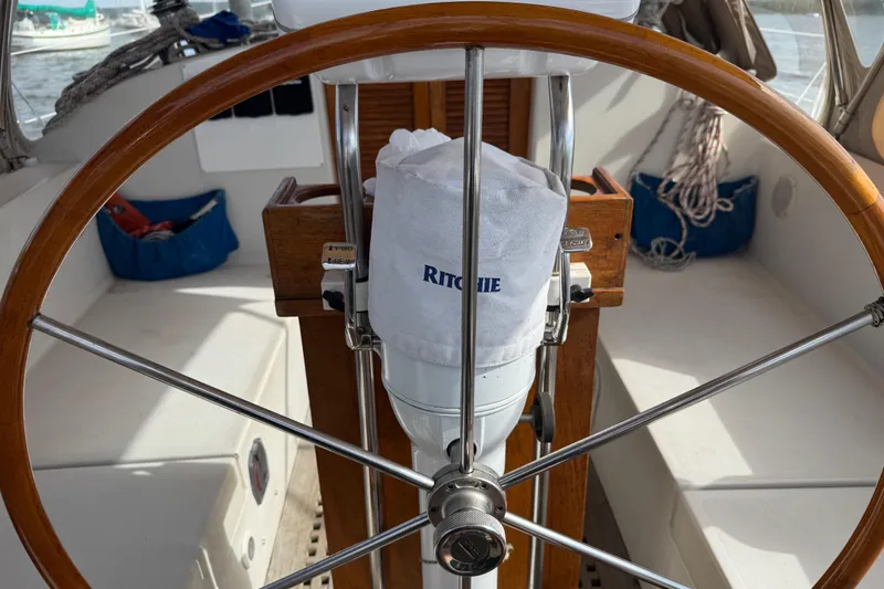 Slide: The Image of Wooden steering wheel on a 1988 Nonsuch 36 sailboat cockpit. - 11