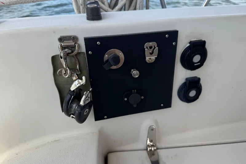 Slide: The Image of Control panel on 1988 Nonsuch 36 sailboat, featuring switches and pulleys. - 13