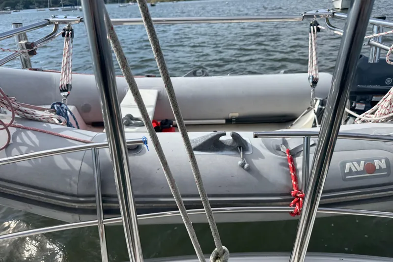 Slide: The Image of 1988 Nonsuch 36 sailboat with Avon dinghy on calm water. - 17