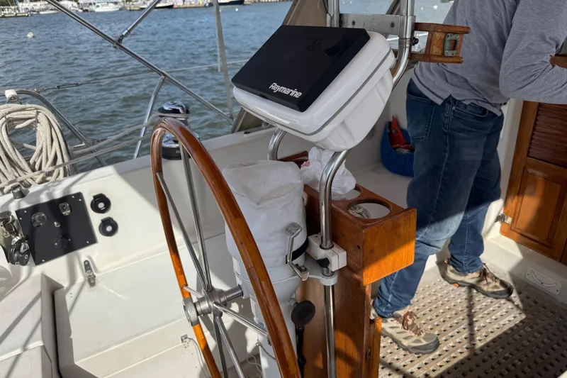 Slide: The Image of Cockpit of 1988 Nonsuch 36 sailboat with wooden wheel and navigation equipment. - 19
