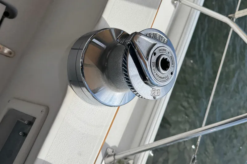 Slide: The Image of Winch on 1988 Nonsuch 36 sailboat, mounted on deck, near water. - 21