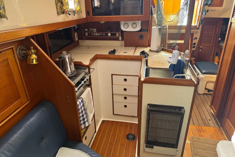 Slide: The Image of Interior of 1988 Nonsuch 36 sailboat with cozy kitchen and seating area. - 25