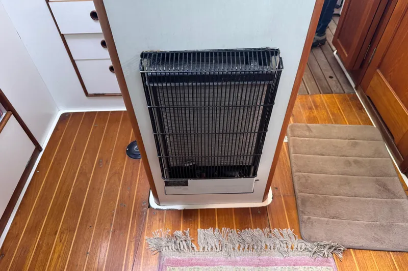 Slide: The Image of Heater inside 1988 Nonsuch 36 sailboat with wooden flooring and storage drawers. - 26