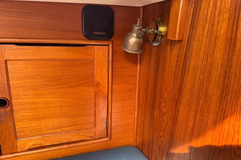 Slide: The Image of Wooden interior of 1988 Nonsuch 36 sailboat with cabinet, light fixture, and speaker. - 30