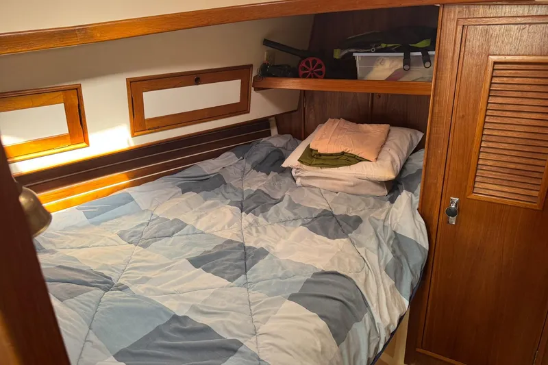 Slide: The Image of Cozy cabin interior of 1988 Nonsuch 36 sailboat with bed and wooden storage. - 33