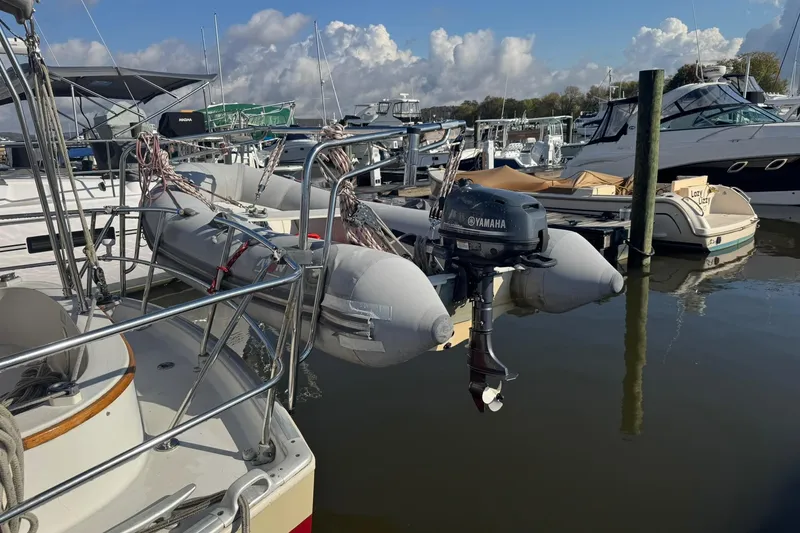 Slide: The Image of 1988 Nonsuch 36 sailboat docked with inflatable dinghy and Yamaha outboard motor. - 36