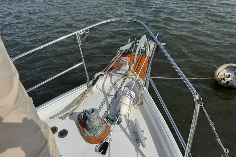 Slide: The Image of Bow of 1988 Nonsuch sailboat with anchor and mooring line in water. - 4