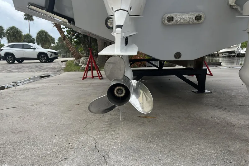 Slide: The Image of 2023 Robalo R302 Center Console boat propeller on a trailer, parked outdoors. - 14